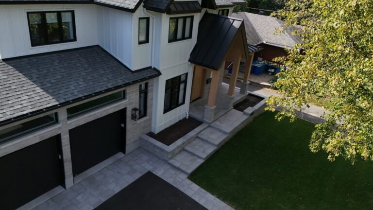 Front entrance with stone steps, interlock and a new lawn at a modern home, built by WLS Landscaping